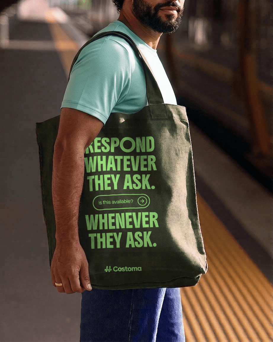 A person carrying a Costoma tote bag printed with the words Respond whatever they ask, whenever they ask